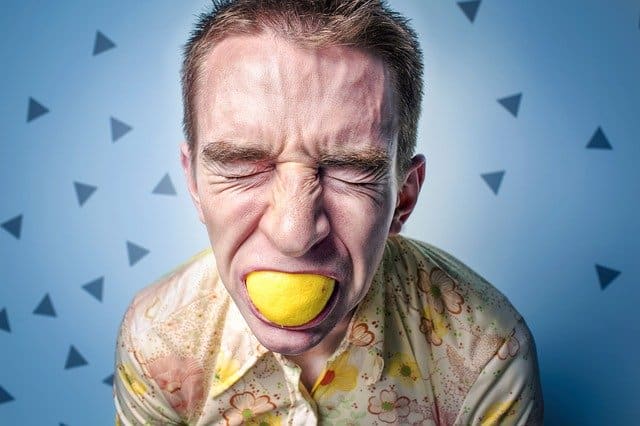 man chewing lemon
